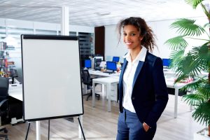 A woman using a whiteboard for a presentation